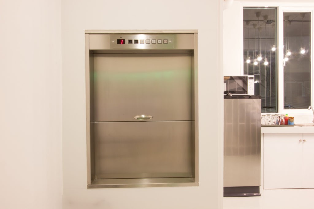 Dumbwaiter lift elevator in a kitchen of rich house used for carrying food or goods